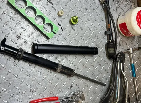 Fork lowers and tools laid out on the bench