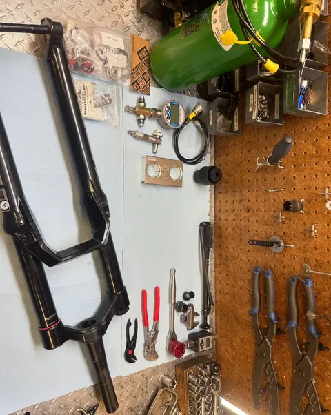 Fork internals laid out on the bench for rebuild