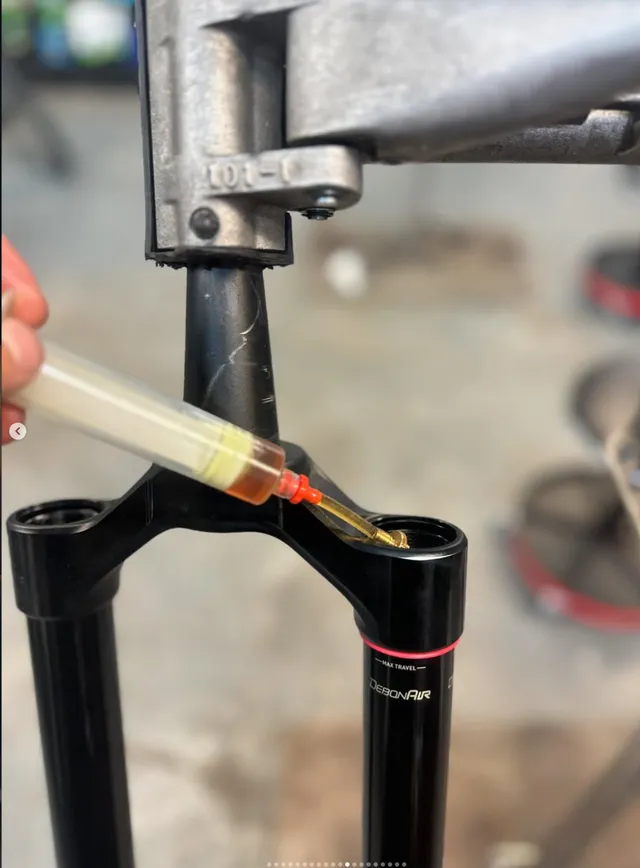 Nitrogen charging a fork's damper during a full rebuild