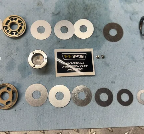 WPS Podium piston kit parts laid out for rebuild