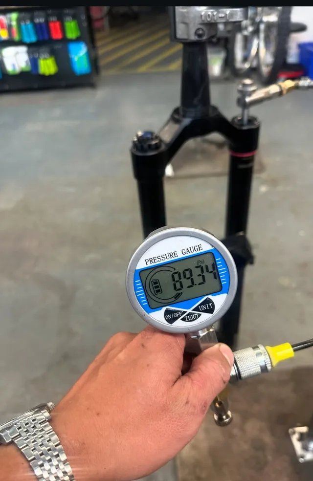 Checking fork air pressure with a digital shock pump gauge