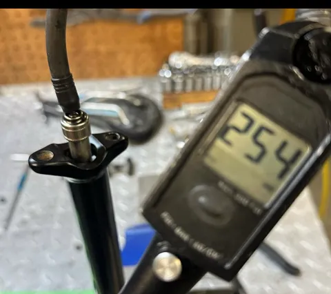 Digital pressure gauge reading a shock's air can