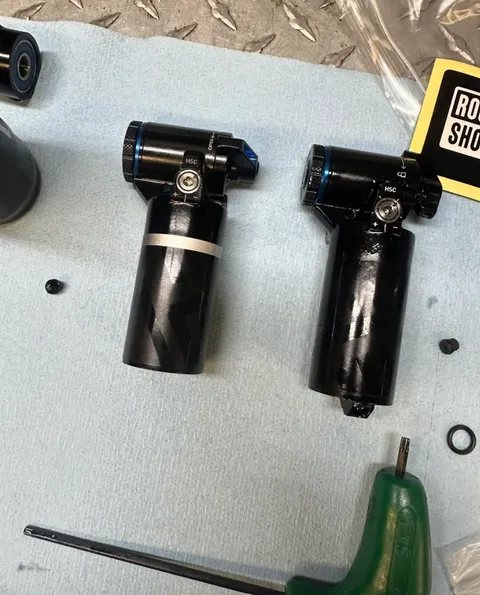Two shock reservoirs disassembled for rebuild